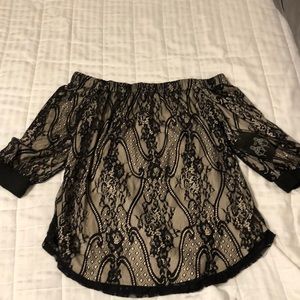 Off the shoulder cream and black blouse.